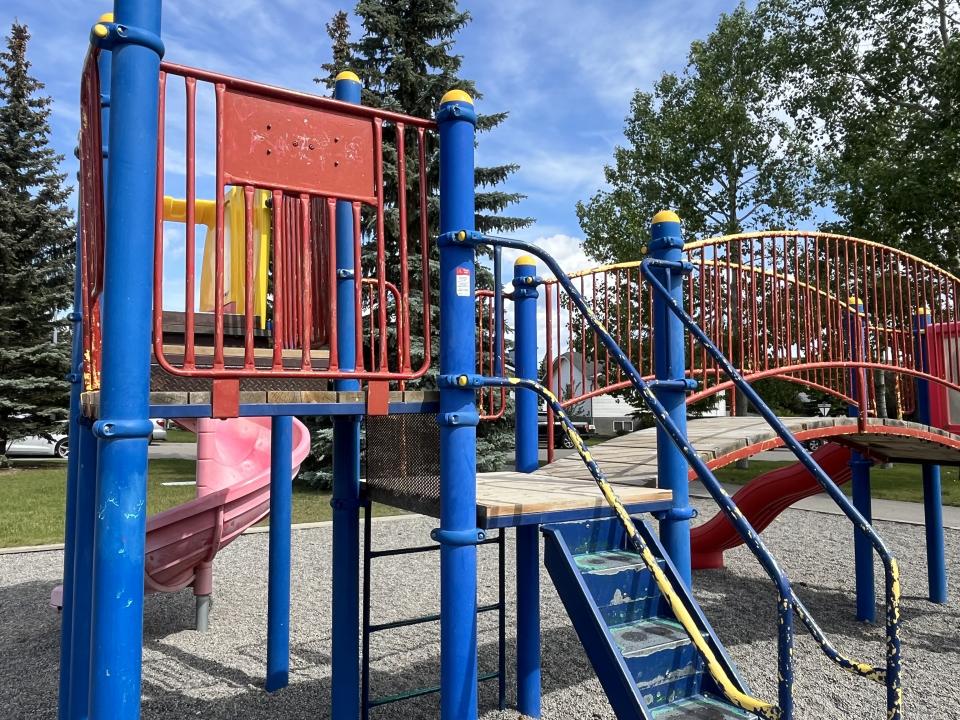 Blue and red playground structure in Samuel Spicer Park, Cochrane. 